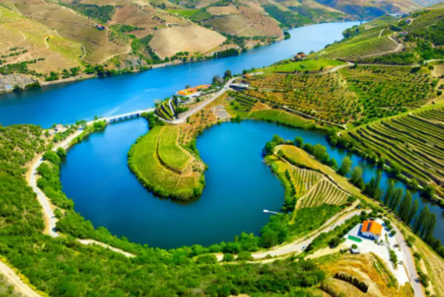 Scenic Duero River flowing through northern Italy with vineyards and riverside town